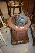 A traditional clay chimney pot and part roll of fencing wire