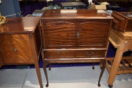 A mid 20th Century mahogany cocktail cabinet on cabriole legs width approx. 77cm, having mirrored