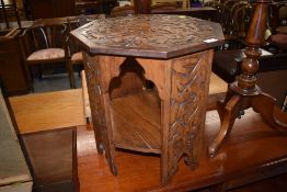 An octagonal carved occasional table, in the Celtic style, width approx. 45cm, height 47cm