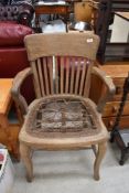 A traditional stripped oak armchair with strung base, upholstery project