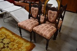 A set of four Victorian dining chairs having upholstered seats and backs