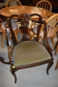 An Edwardian inlaid salon armchair