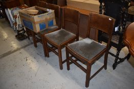 A set of four mid 20th Century oak dining chairs, having velvet upholstered seats and solid backs