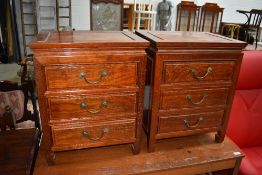 A pair of Indonesian hardwood three drawer bedside chests , each approx. 46cm wide
