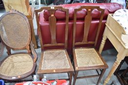 A pair of Edwardian mahogany cane seated bedroom chairs having line inlay decoration