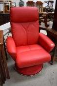 A modern (2015) retro style red leather or leatherette swivel recliner chair on chrome frame, get