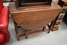 A mid 20th Century oak twist gate leg table