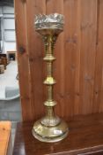 A large brass candlestick of ecclesiastical form, height approx. 52cm