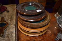 A selection of hand turned ecclesiastical collection or offering plates,including oak and teak.