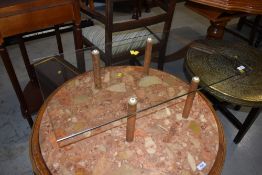 An interesting vintage glass topped coffee table on four wooden legs of cylindrical form, approx. 76