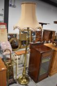 An Edwardian brass standard lamp, on swag column and triple claw footed base