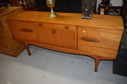 A gorgeous vintage teak sideboard having contrasted stylised handles and shaped legs, width