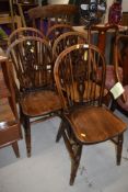 A set of five traditional oak wheelback kitchen chairs