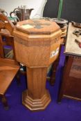 An early 20th century oak baptism font having copper liner,carved with ' He took them up in his arms