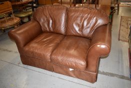 A brown leather two seater settee by Laura Ashley , width approx. 153cm