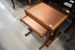 A vintage nest of three teak and copper tables, largest one width 53cm, labelled G Plan