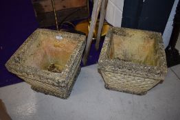 A pair of concrete garden planters