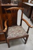 A 19th Century stained frame arm chair having splat back and upholstered seat