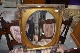A reproduction gilt frame wall mirror, foliate frame with oval mirror, approx. 52 x 62cm