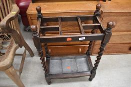 An early 20th Century oak twist frame umbrella/stick stand, including drip tray, approx width 44cm