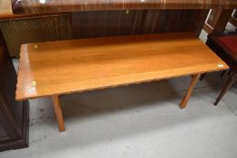 A golden oak coffee table having wave edge, approx. 120 x 44cm