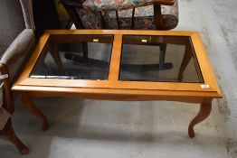 A modern yew effect and smoked glass top coffee table, approx. 96 x 49cm
