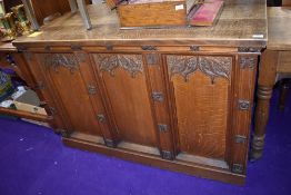 A church vestibule tabernacle base having extensive gothic decoration in traditional oak with
