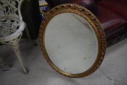 A vintage gilt oval wall mirror, approx. 70 x 55cm