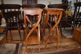 A pair of hardwood plant stands, having stylised frames, each approx. height 75cm
