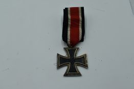 A WW2 German Iron cross with Swastika and 1939 on face, 1813 on reverse, with ribbon