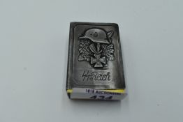 A German WW2 White Metal Matchbox Cover having German Helmet, Iron Cross and Oak Leaves decoration