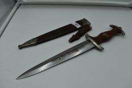 A German SA Service Dagger c1933 with metal scabbard, grip with National Socialist Emblem and SA