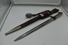 A German Third Reich Police Dagger, brown leather and metal scabbard, silver portepee knot, single