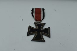 A German WW2 Second Class Iron Cross, Swastika and 1939 on face, 1813 on reverse, with ribbon,