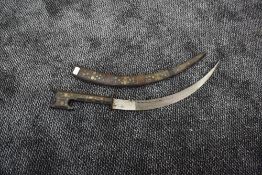 A North African large Cured Dagger having decorated wooden grip and scabbard