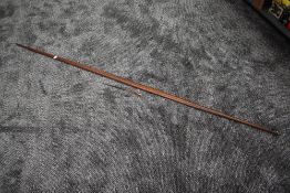 A possibly medieval wooden Long Bow, flat to one side and other side curved, with unassociated metal