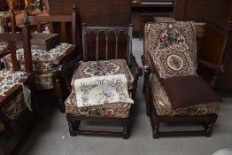 A pair of reclined low arm chairs in a farm house design by Ercol