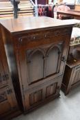 A priory styled oak cupboard having internal compartments