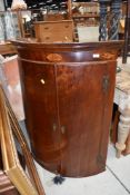 A 19th Century mahogany and inlaid bow fronted corner cupboard