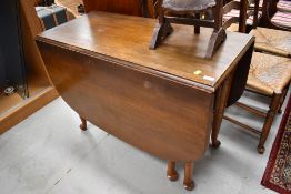 An early to mid 20th Century oak gate leg table, on Queen Anne style legs, width approx. 107cm