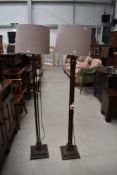 A pair of modern bronze effect standard lamps