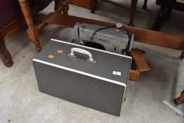 A vintage sewing machine in case, Merritt
