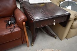A 19th Century stained frame table, having drop flap, frieze drawer, on turned pedestal over