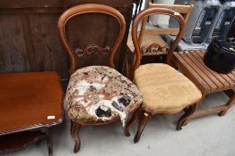 Two Victorian balloon back dining chairs having carved detailing