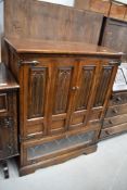 An oak television or music cabinet having open front with storage underneath by Old Charm