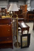 A modern brass standard lamp with adjustable arm