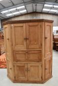 A Victorian stripped pine pantry cupboard, having panelled doors and drop flap centre section,