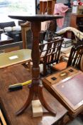 A 19th Century occasional mahogany pedestal table having circular top of small proportions on turne