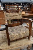 A vintage oak frame low seat armchair