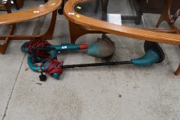 Two electric grass strimmers